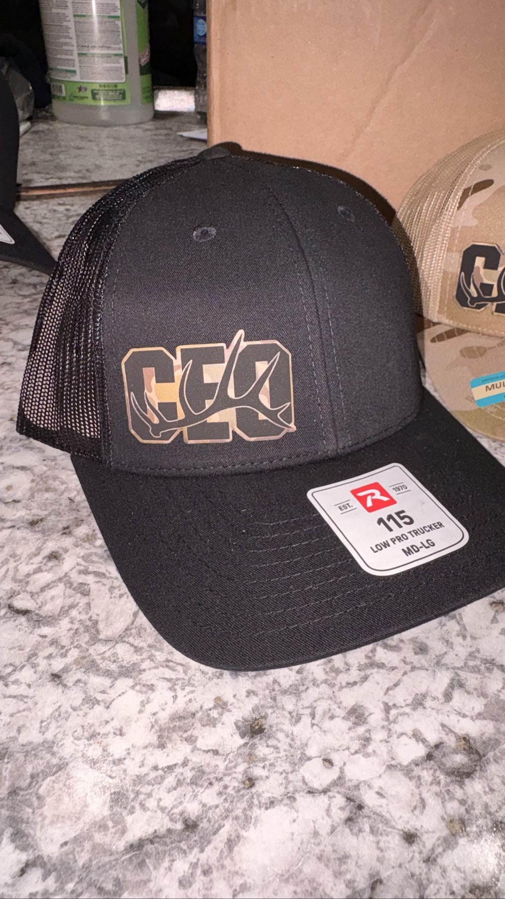 Black trucker hat with custom logo by KB Custom Creations
