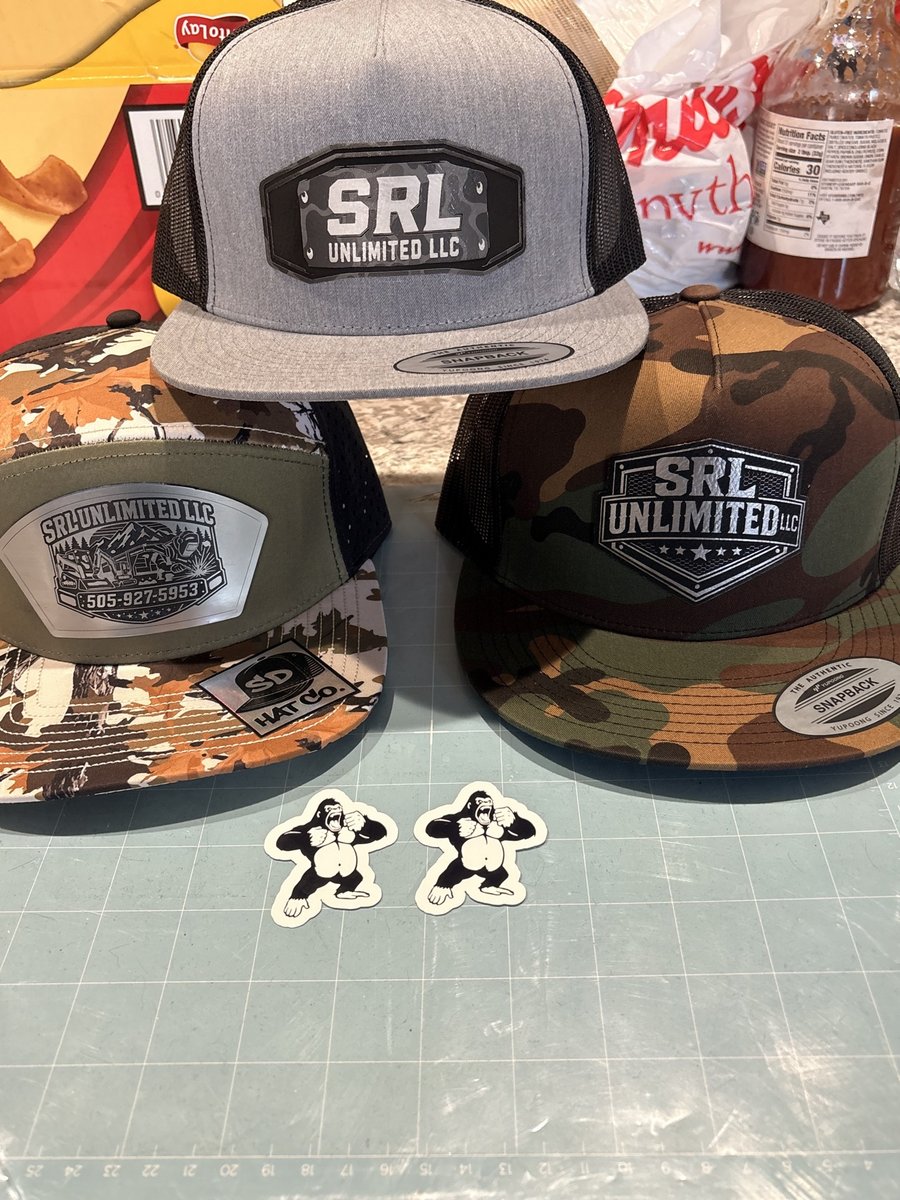 Three SRL Unlimited LLC patch hats in gray and camo with gorilla stickers, made by KB Custom Creations