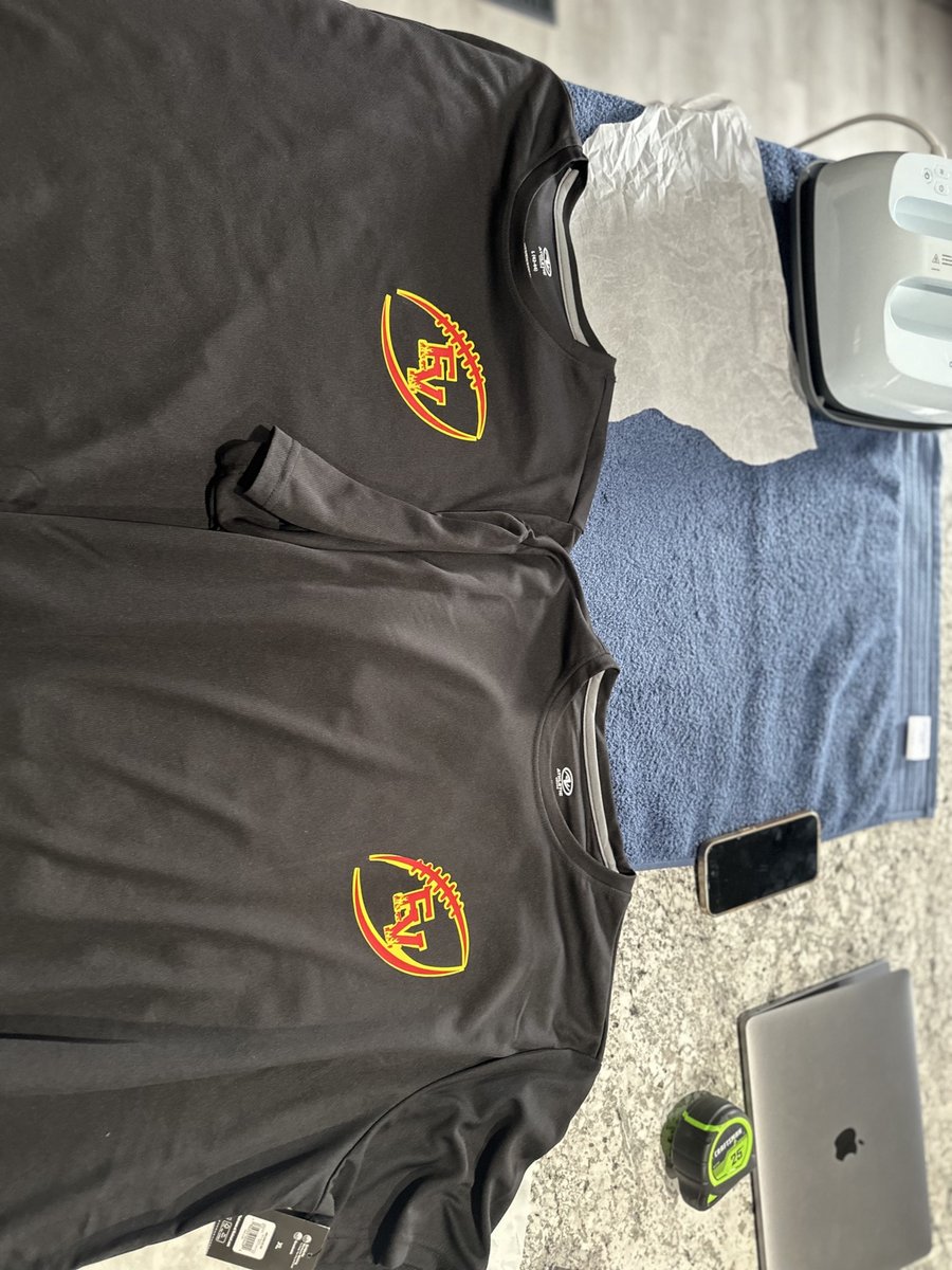Two black team shirts with a football chest logo on the front, made by KB Custom Creations