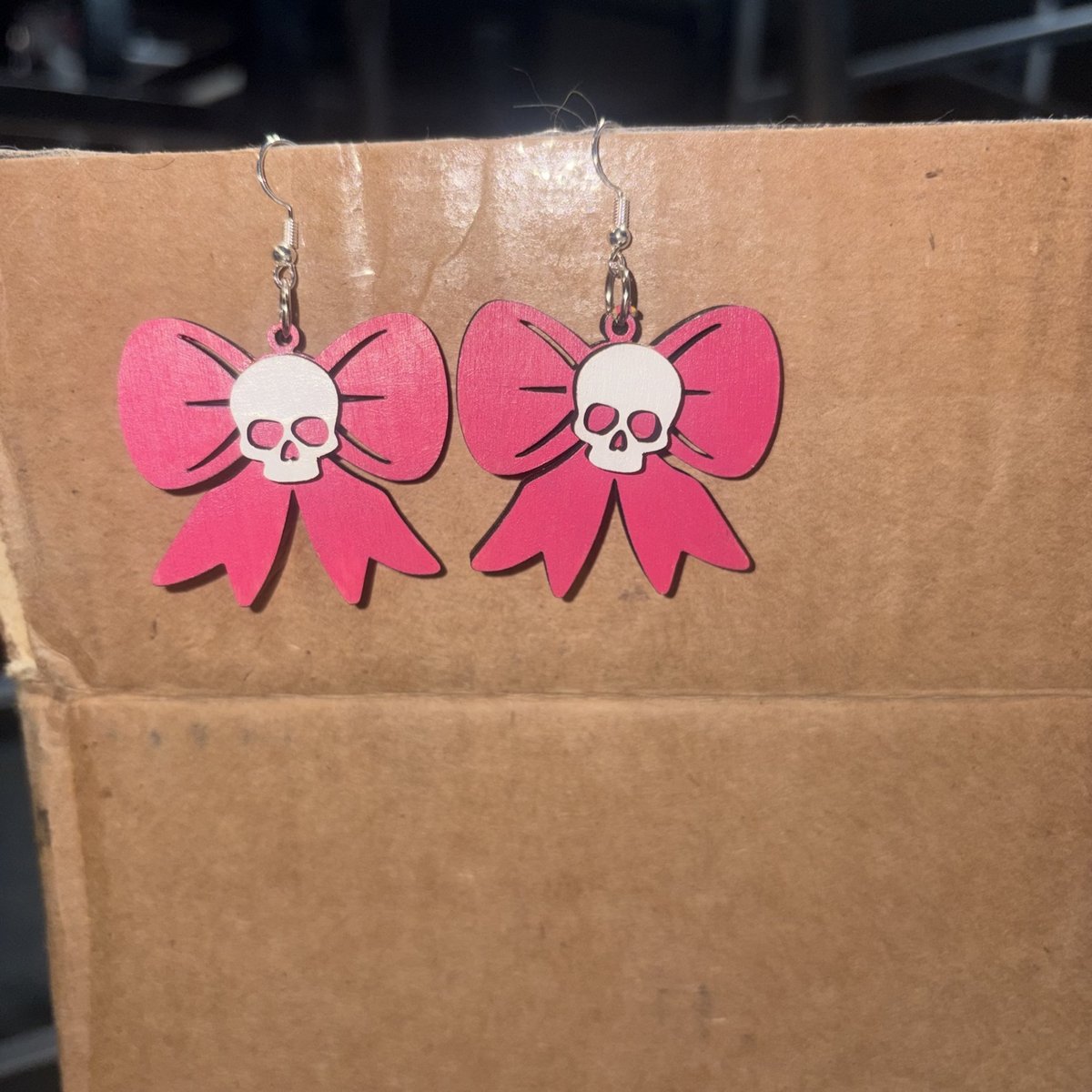Pink bow earrings with a white skull center, by KB Custom Creations