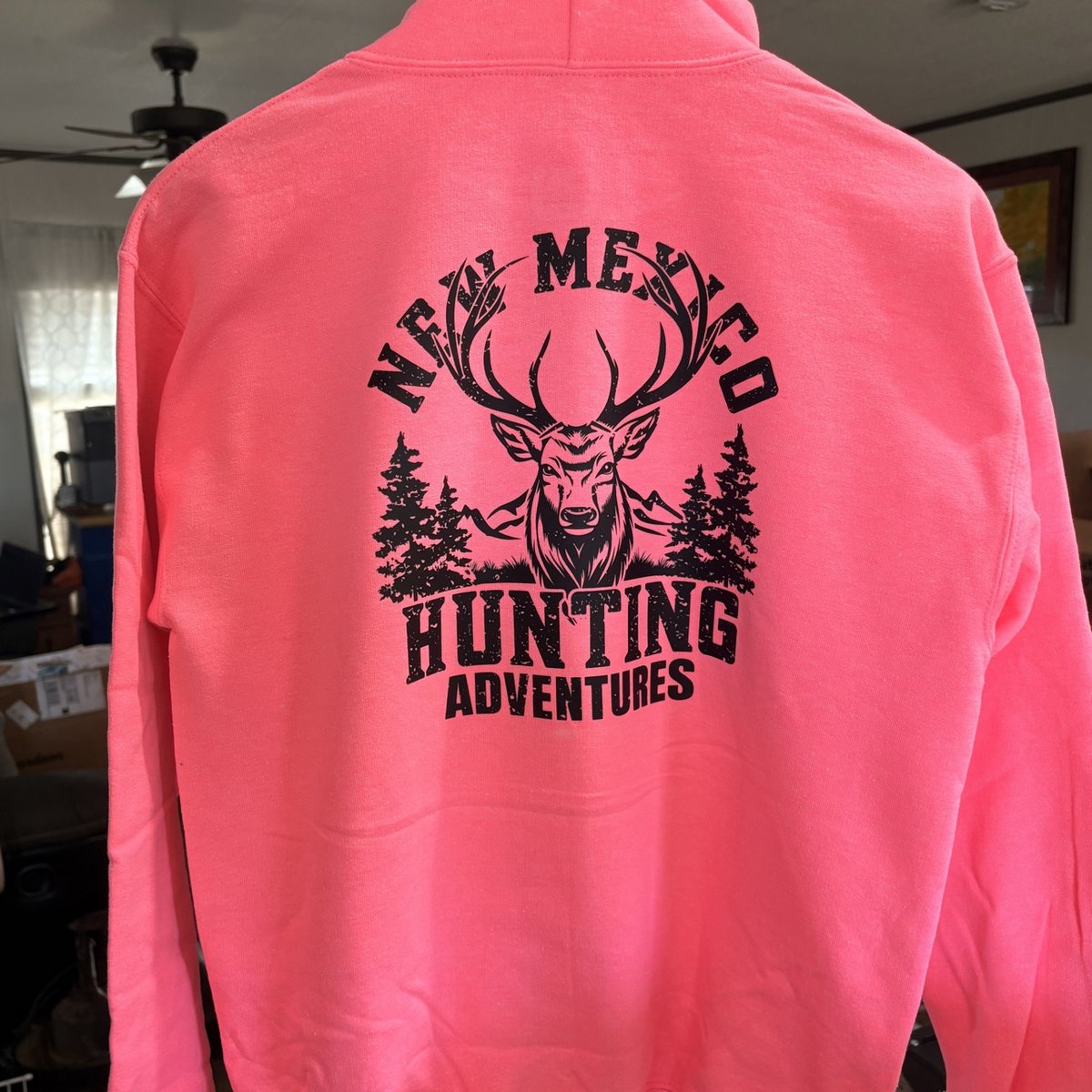 Hot pink hoodie with the New Mexico Hunting Adventures deer design on the back, made by KB Custom Creations