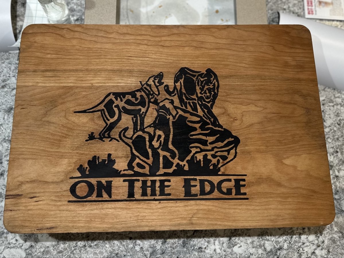 Engraved wood board with hounds and a mountain lion and the words On The Edge, by KB Custom Creations