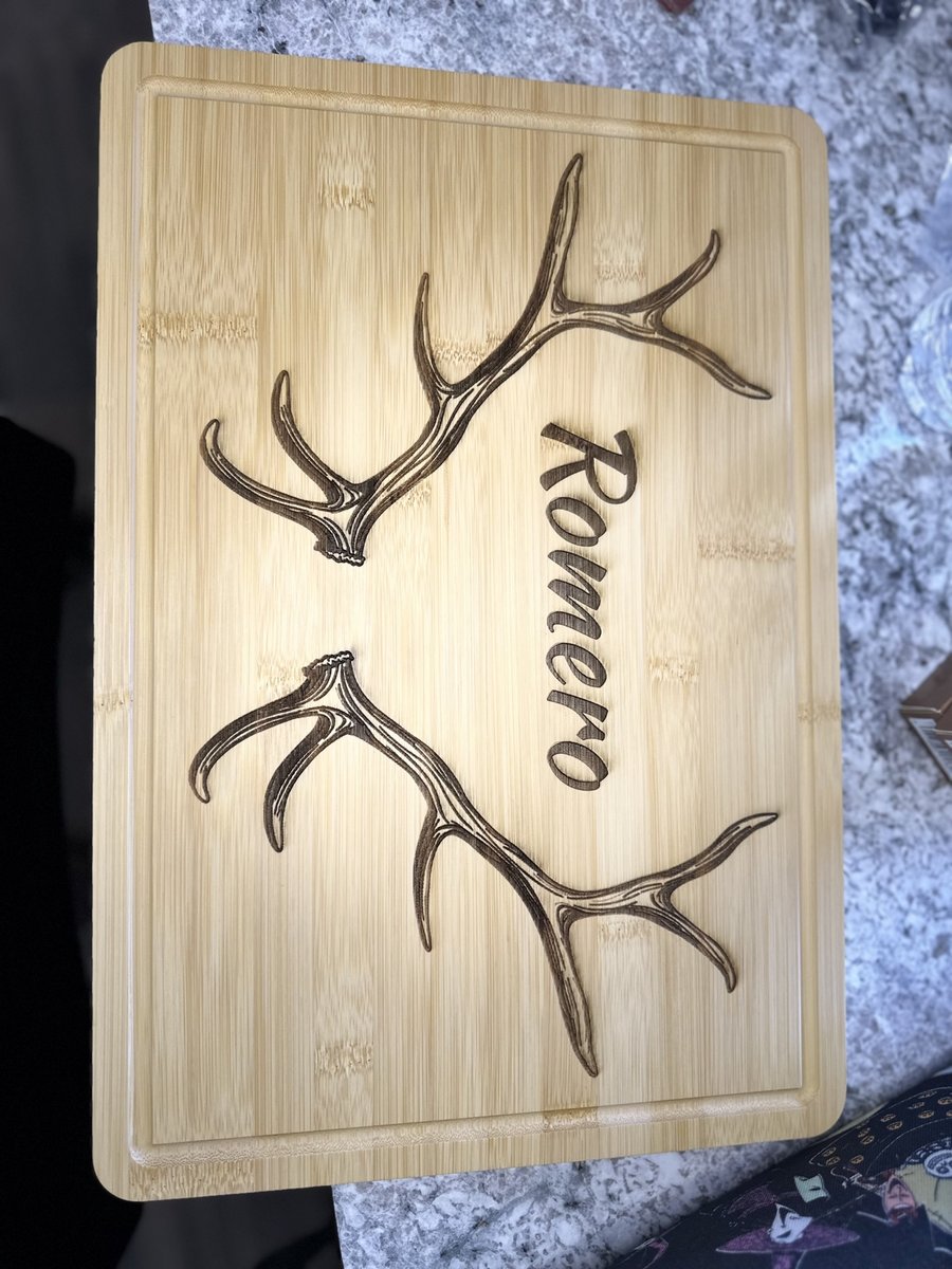 Bamboo cutting board engraved with antlers and a family name, by KB Custom Creations