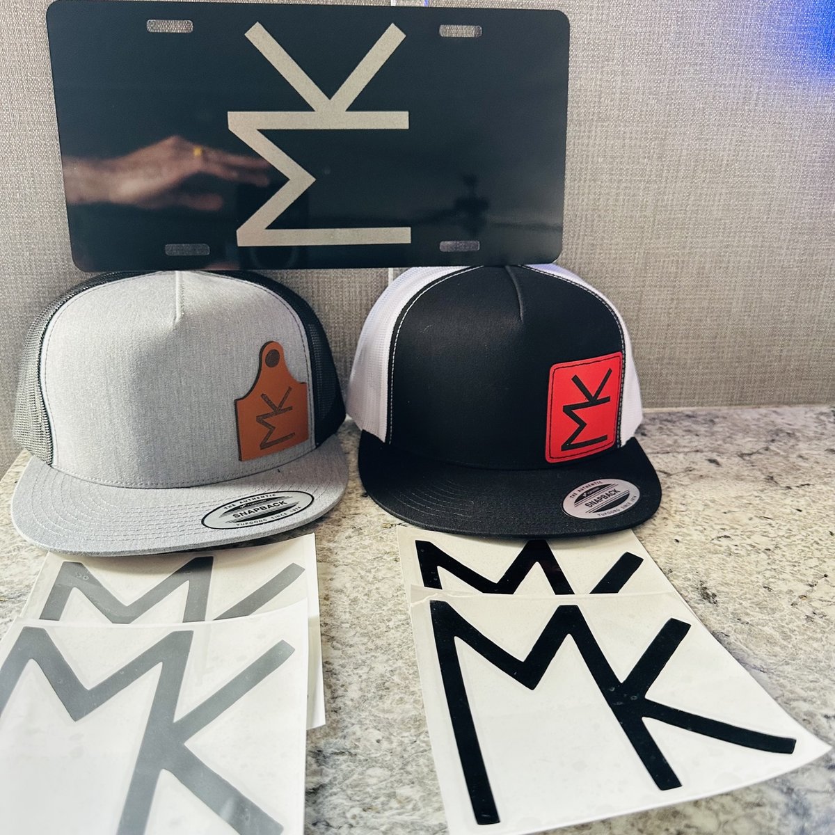 Matching cattle-brand set with an engraved plate, two patch hats, and decals in the same brand mark, by KB Custom Creations