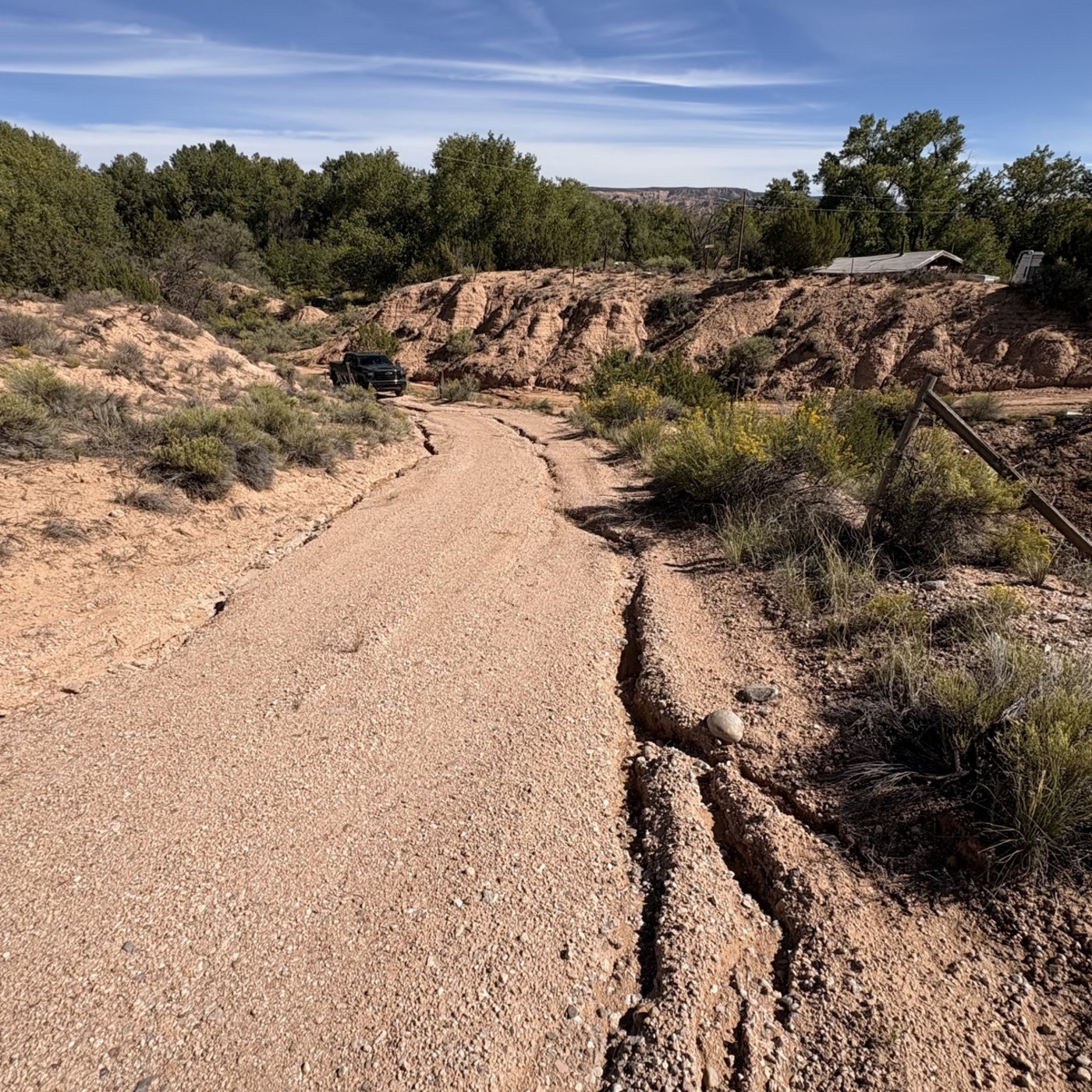 Dirt road washed out with deep erosion ruts before BK Hauling & Clearing repair